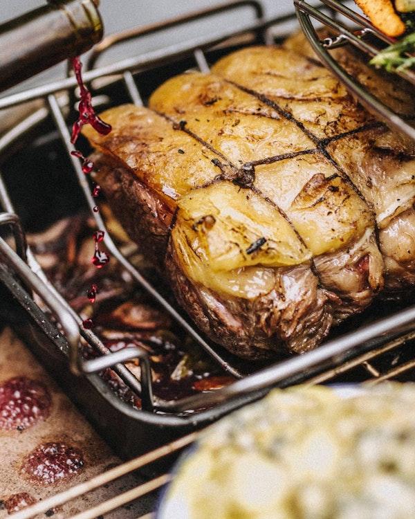 Rectangular drip pan with roasted sirloin of beef and red wine gravy