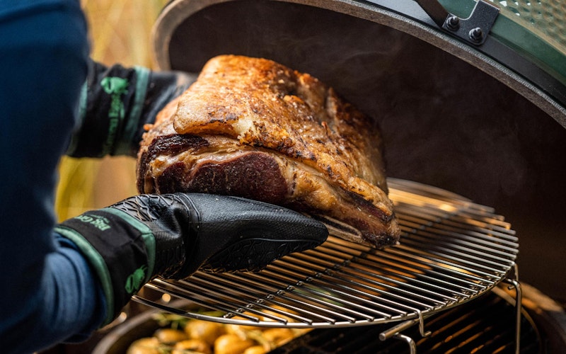 Heat Resistant Silicone BBQ Mitt with Fabric Cuff holding a rib of beef